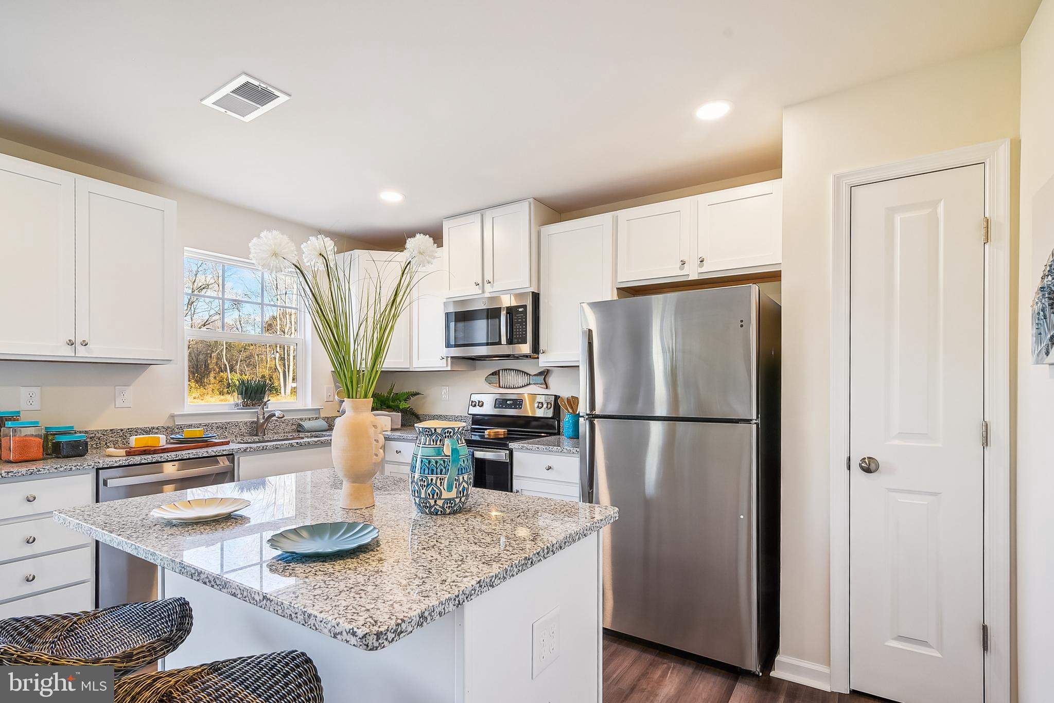 9716 Camp Road Laurel, DE 19956 - Photo 7 of 25 a kitchen with a refrigerator a stove a sink dishwasher and wooden cabinets with wooden floor