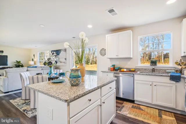 a kitchen with granite countertop a sink and cabinets