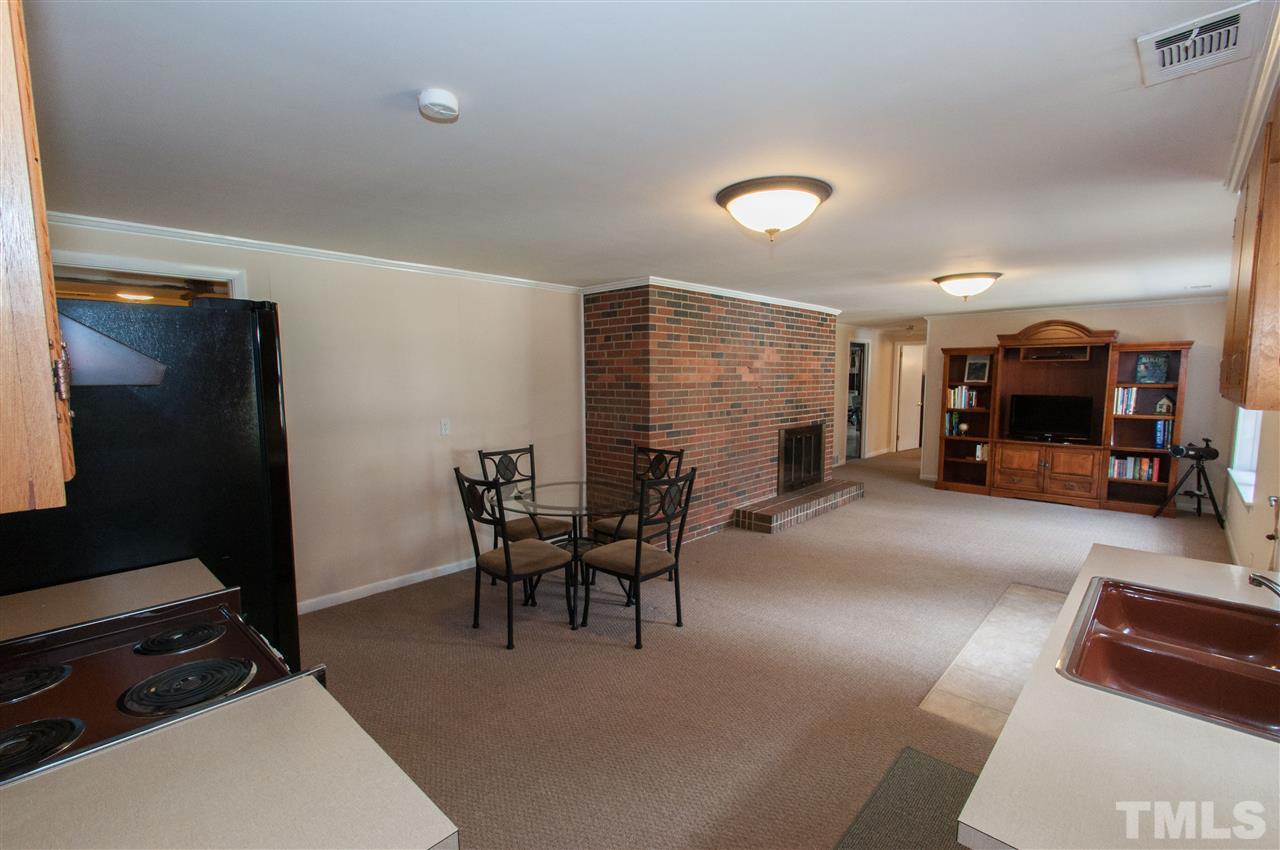 4001 Sue Lane Raleigh, NC 27604 - Photo 14 of 25 a dining room with furniture and a flat screen tv