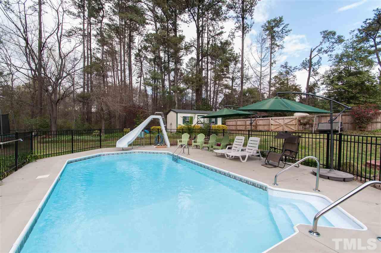 4001 Sue Lane Raleigh, NC 27604 - Photo 22 of 25 a view of a swimming pool with a patio and wooden tub