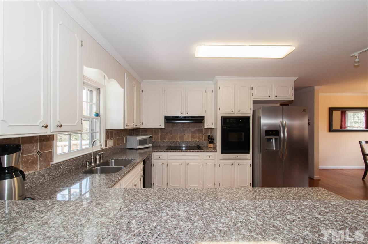 4001 Sue Lane Raleigh, NC 27604 - Photo 8 of 25 a kitchen with stainless steel appliances granite countertop a refrigerator a stove and a sink