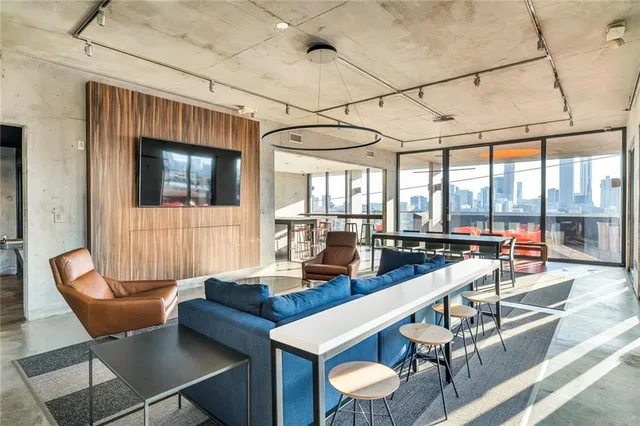 a living room with furniture and floor to ceiling windows