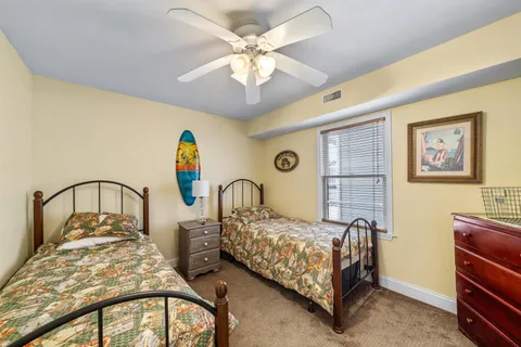 a bedroom with bed and a chandelier