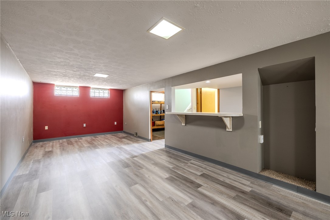 29971 Regent Road Wickliffe, OH 44092 - Photo 35 of 39 Unfurnished living room featuring a textured ceiling and wood finished floors