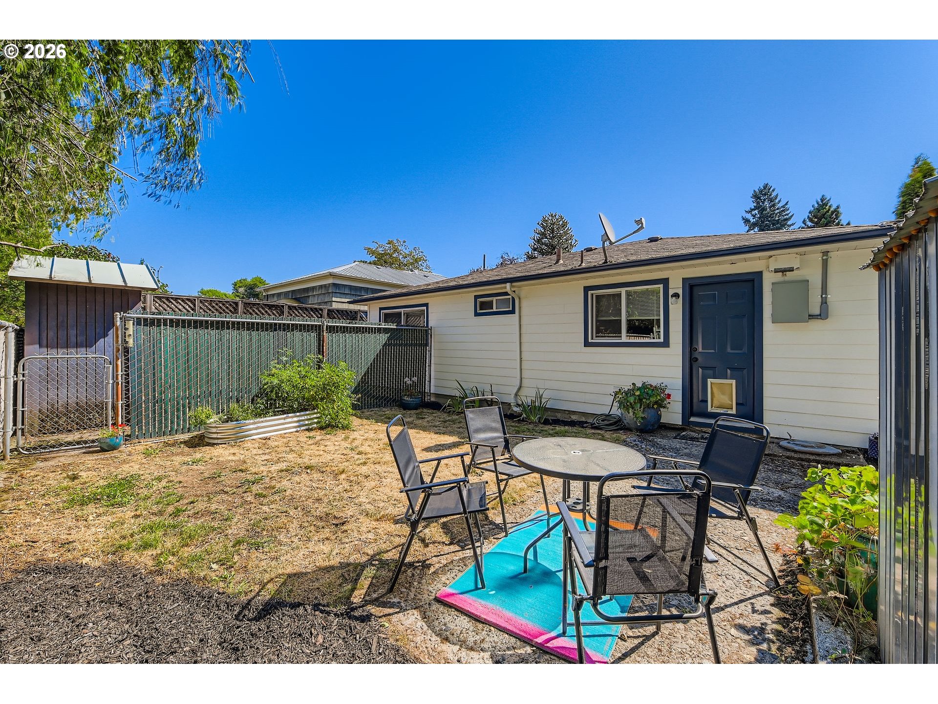 1643 Northeast 74th Avenue Portland, OR 97213 - Photo 20 of 24 a view of a patio with table and chairs with wooden fence and plants