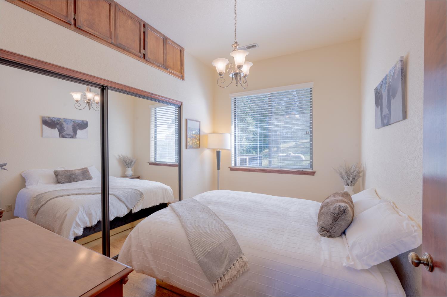 5912 Old Gulch Road San Andreas, CA 95249 - Photo 12 of 71 a bedroom with two beds and a chandelier