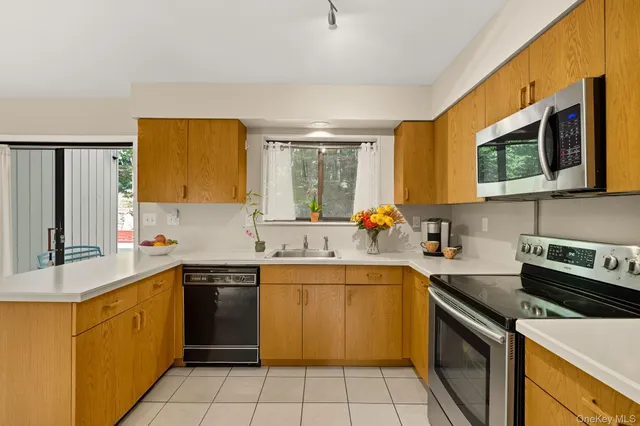 a kitchen with a sink stove top oven and microwave
