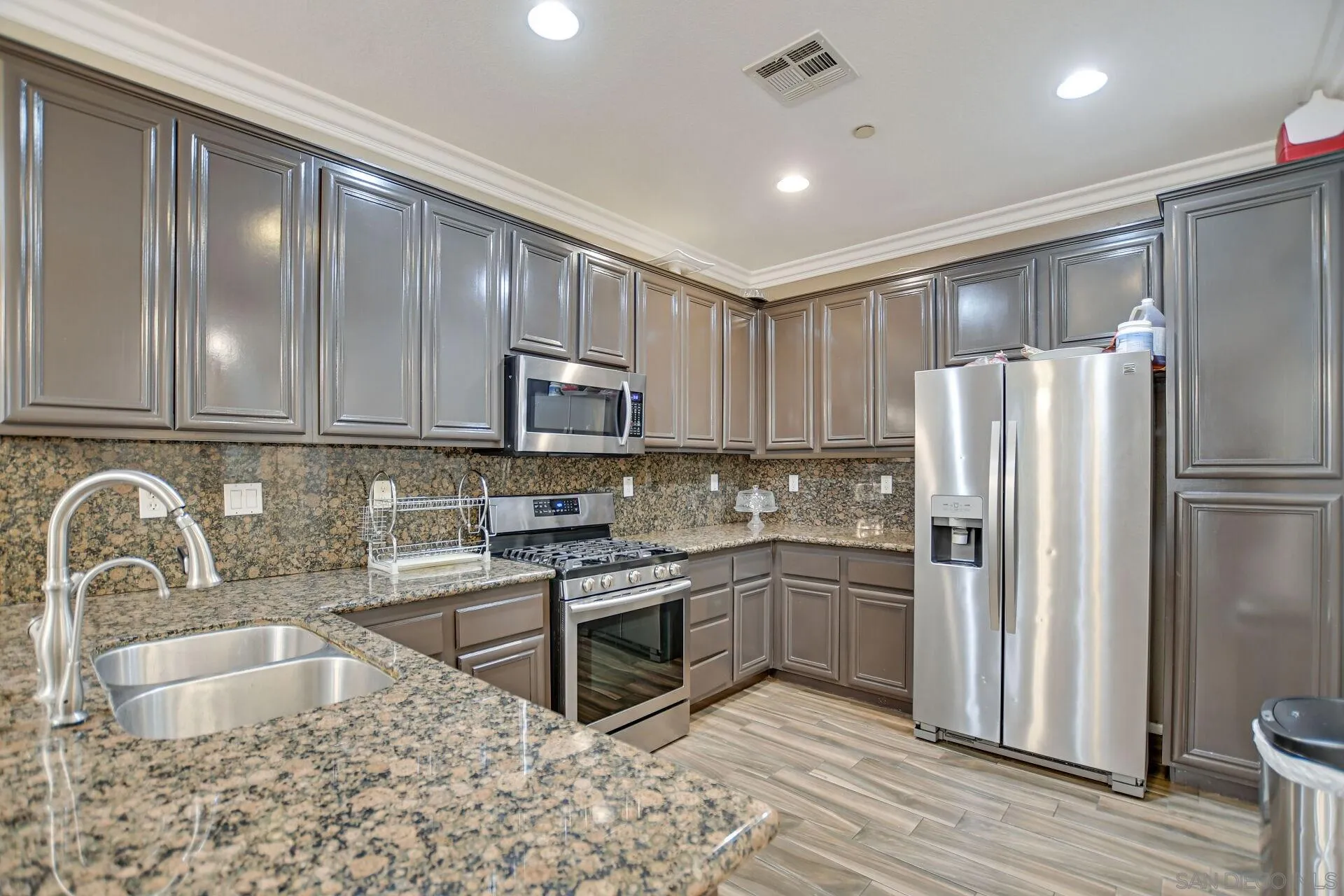 6346 Southern Place Riverside, CA 92504 - Photo 12 of 33 a kitchen with stainless steel appliances granite countertop a refrigerator sink and stove