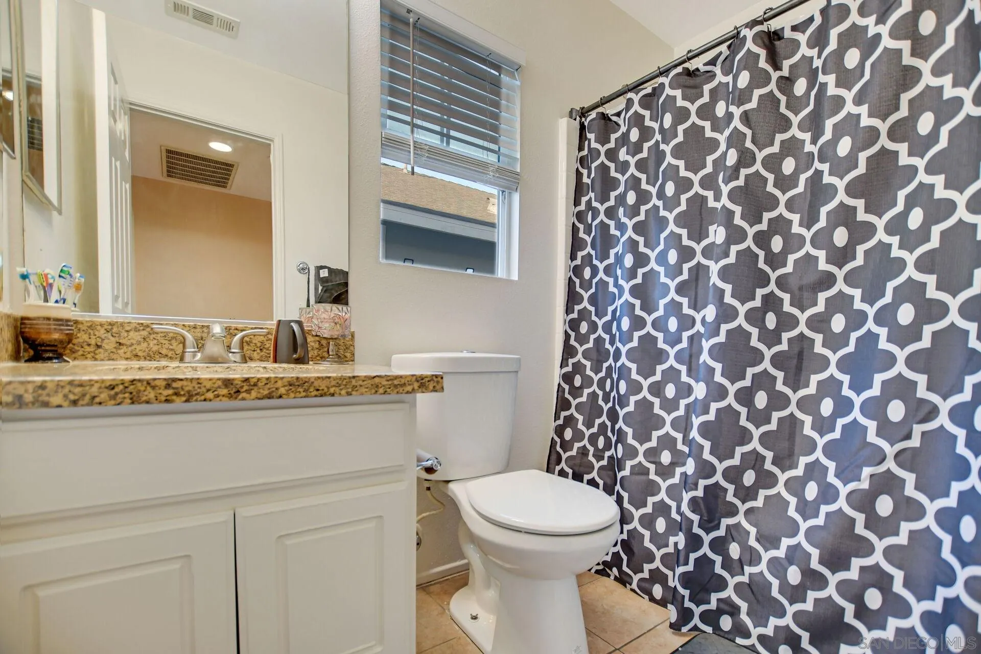 6346 Southern Place Riverside, CA 92504 - Photo 22 of 33 a bathroom with a granite countertop sink and a toilet