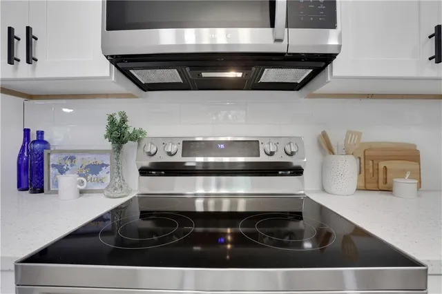a stove top oven sitting inside of a kitchen