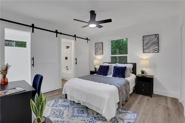 a bedroom with a bed window and a desk