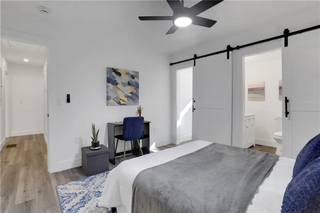 a bedroom with a bed and a chandelier