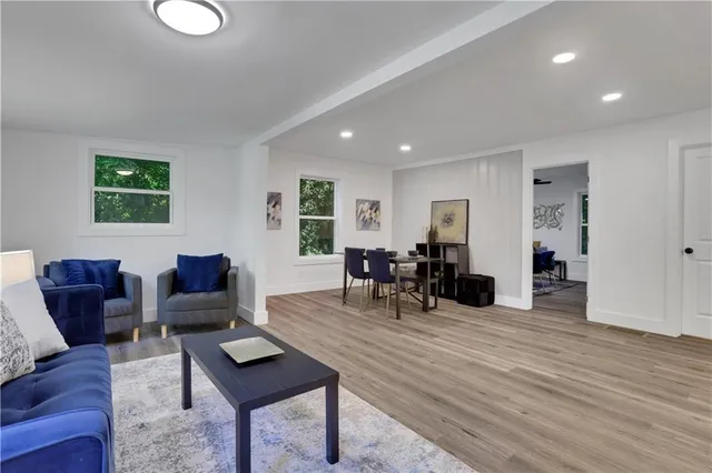 a living room with furniture and wooden floor
