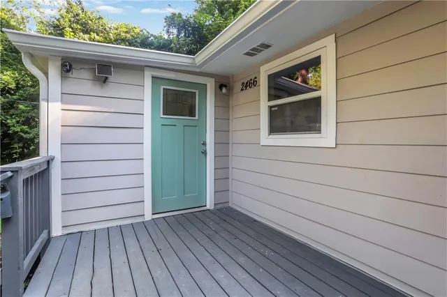 a view of front door and deck of the house
