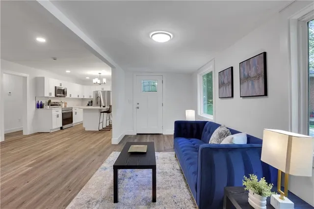 a living room with furniture and a wooden floor
