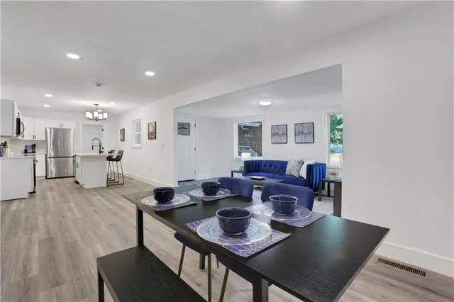 a view of a dining room with furniture and wooden floor