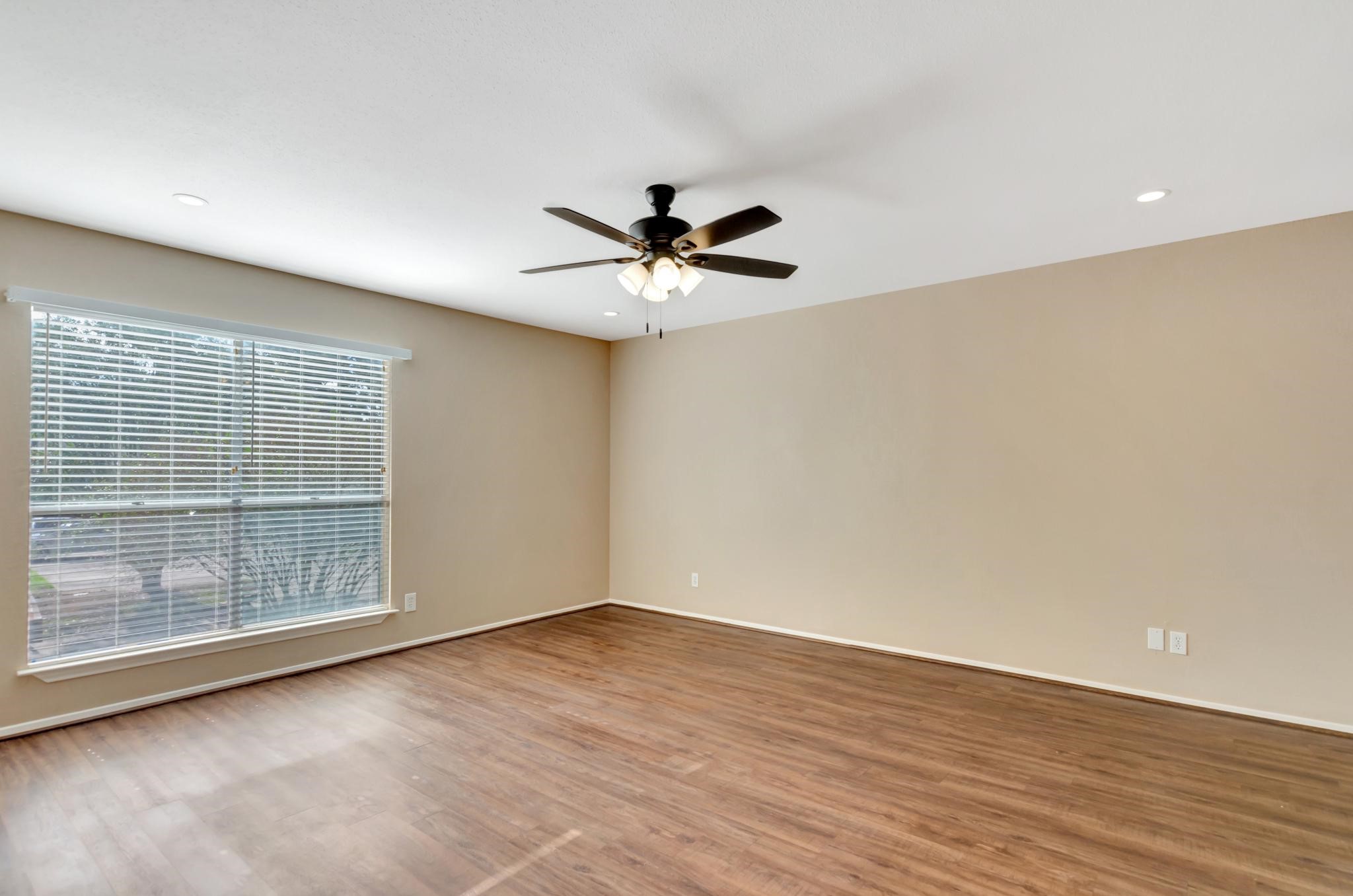 14555 Wunderlich Drive, Unit 2902 Houston, TX 77069 - Photo 12 of 33 wooden floor in an empty room with a window