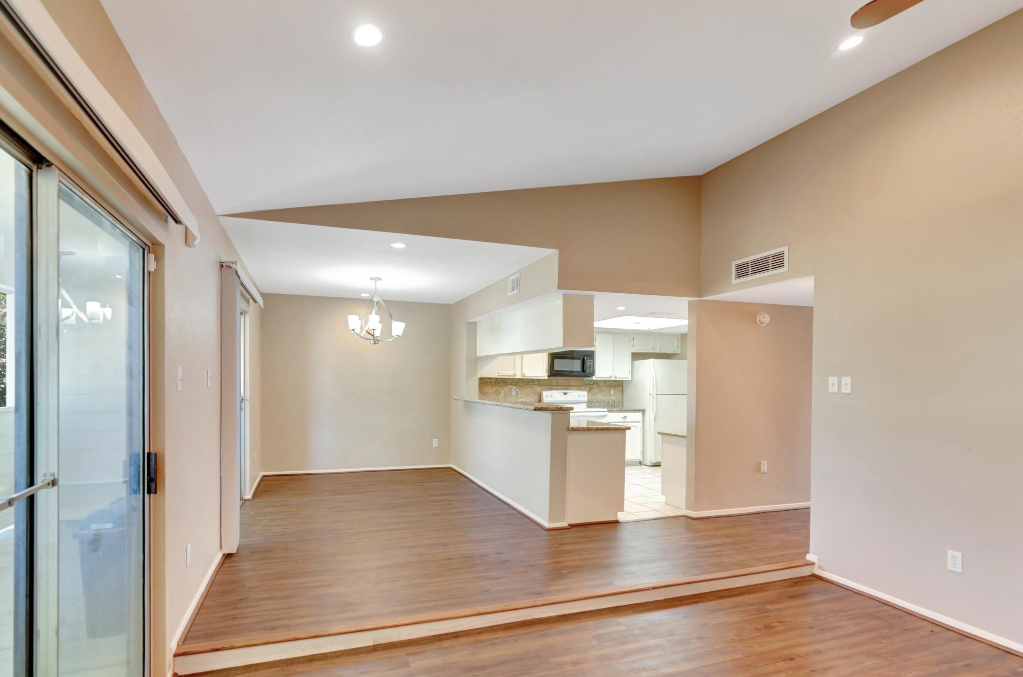 14555 Wunderlich Drive, Unit 2902 Houston, TX 77069 - Photo 5 of 33 a view of a kitchen with a sink a refrigerator and wooden floor