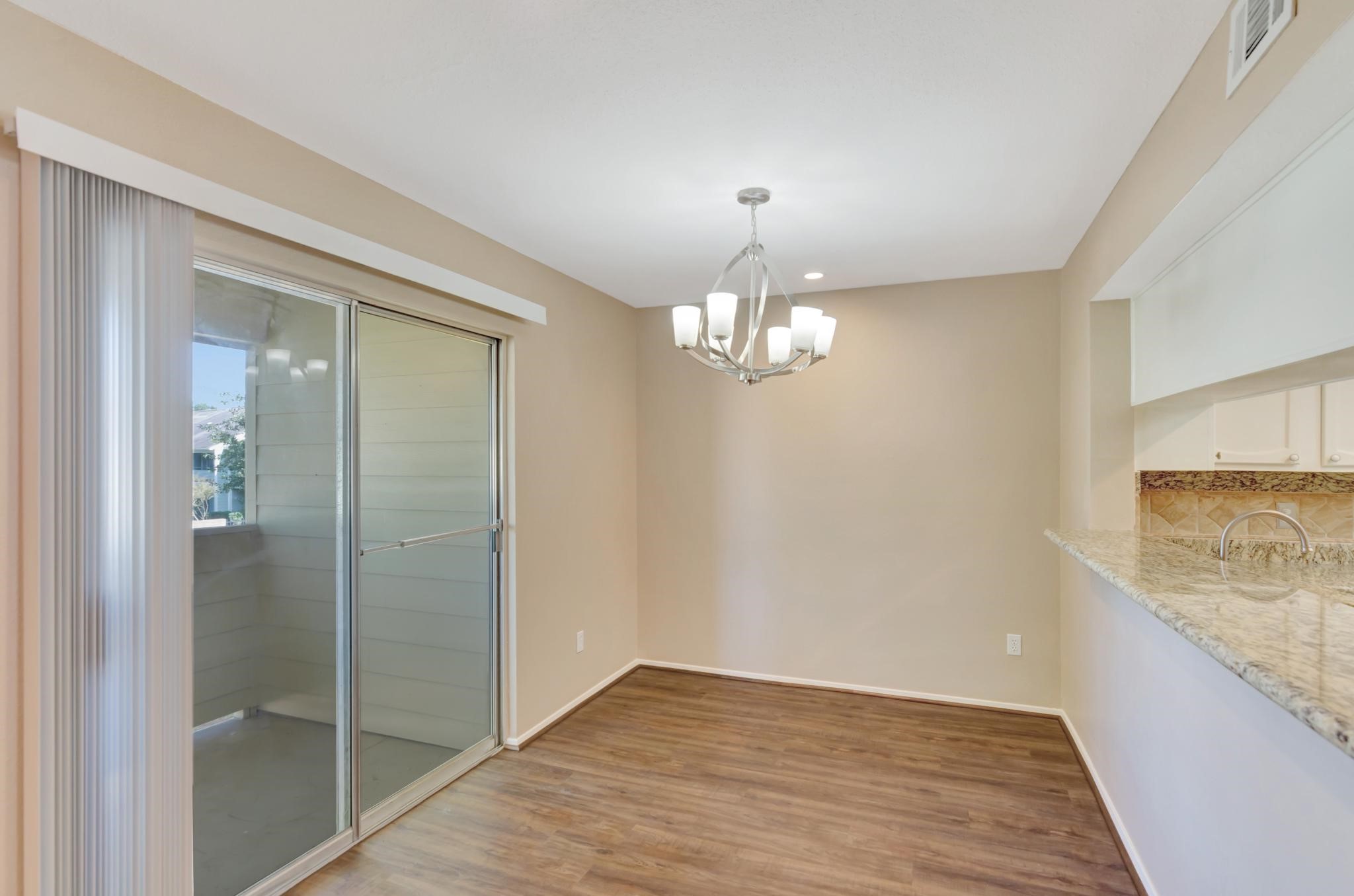 14555 Wunderlich Drive, Unit 2902 Houston, TX 77069 - Photo 6 of 33 an empty room with wooden floor mirror and windows
