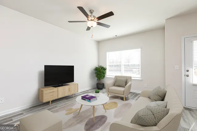 a living room with furniture and a flat screen tv
