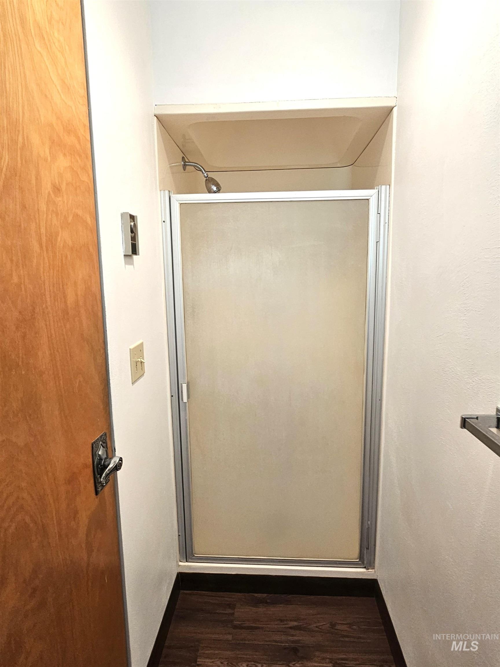 29865 Mission Creek Road Culdesac, ID 83524 - Photo 15 of 43 Compact shower enclosure with a frosted glass door and chrome fixtures