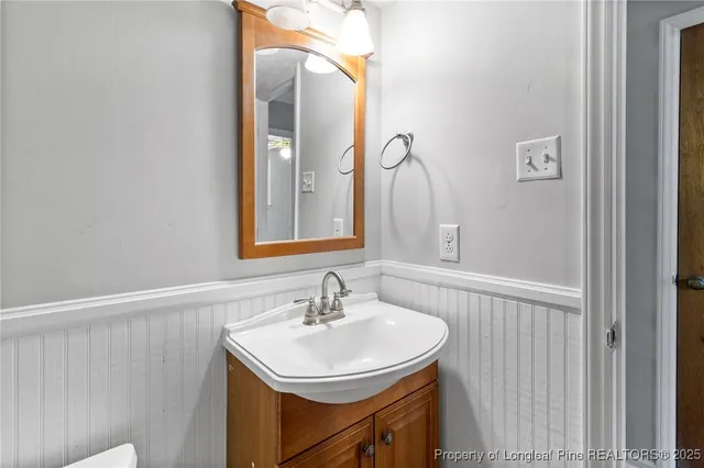 a bathroom with a sink vanity and a mirror