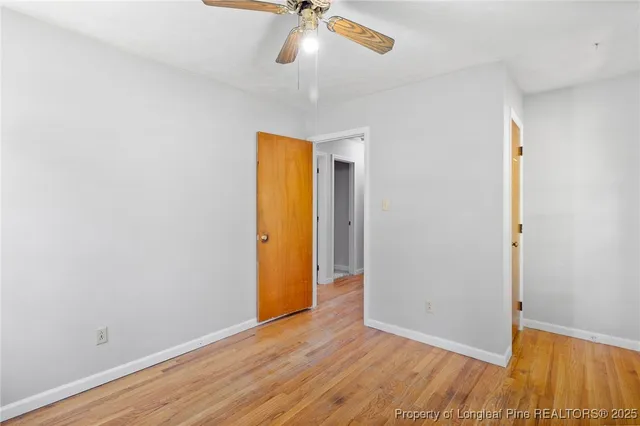 an empty room with a empty space and a ceiling fan