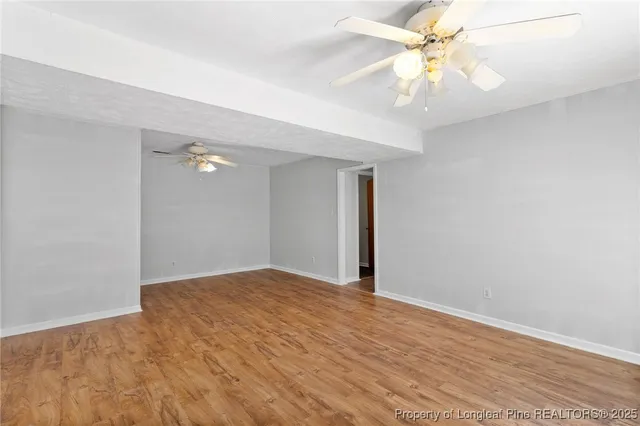 a view of an empty room with a fan