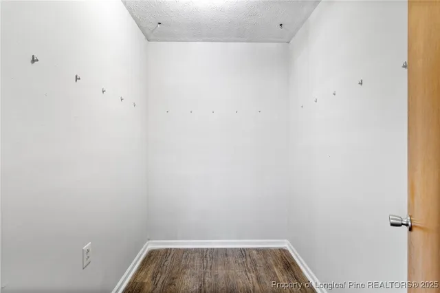 a view of hallway with stairs and wooden floor