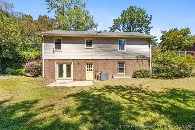 a big house with big yard and large trees