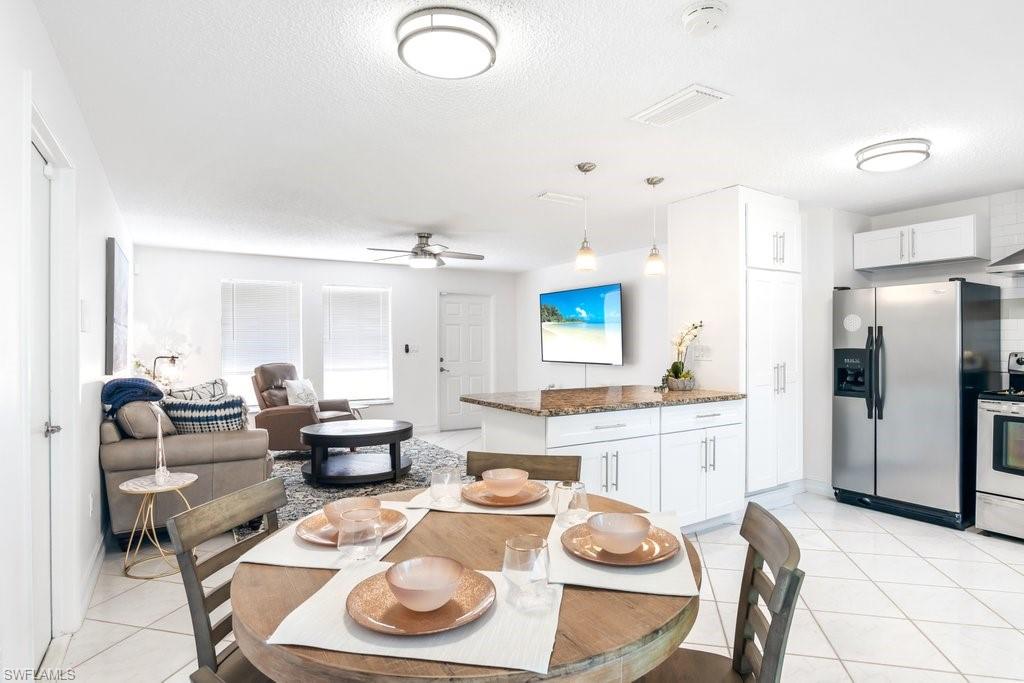 1207 Hernando Street Naples, FL 34103 - Photo 7 of 37 a large kitchen with a table and chairs