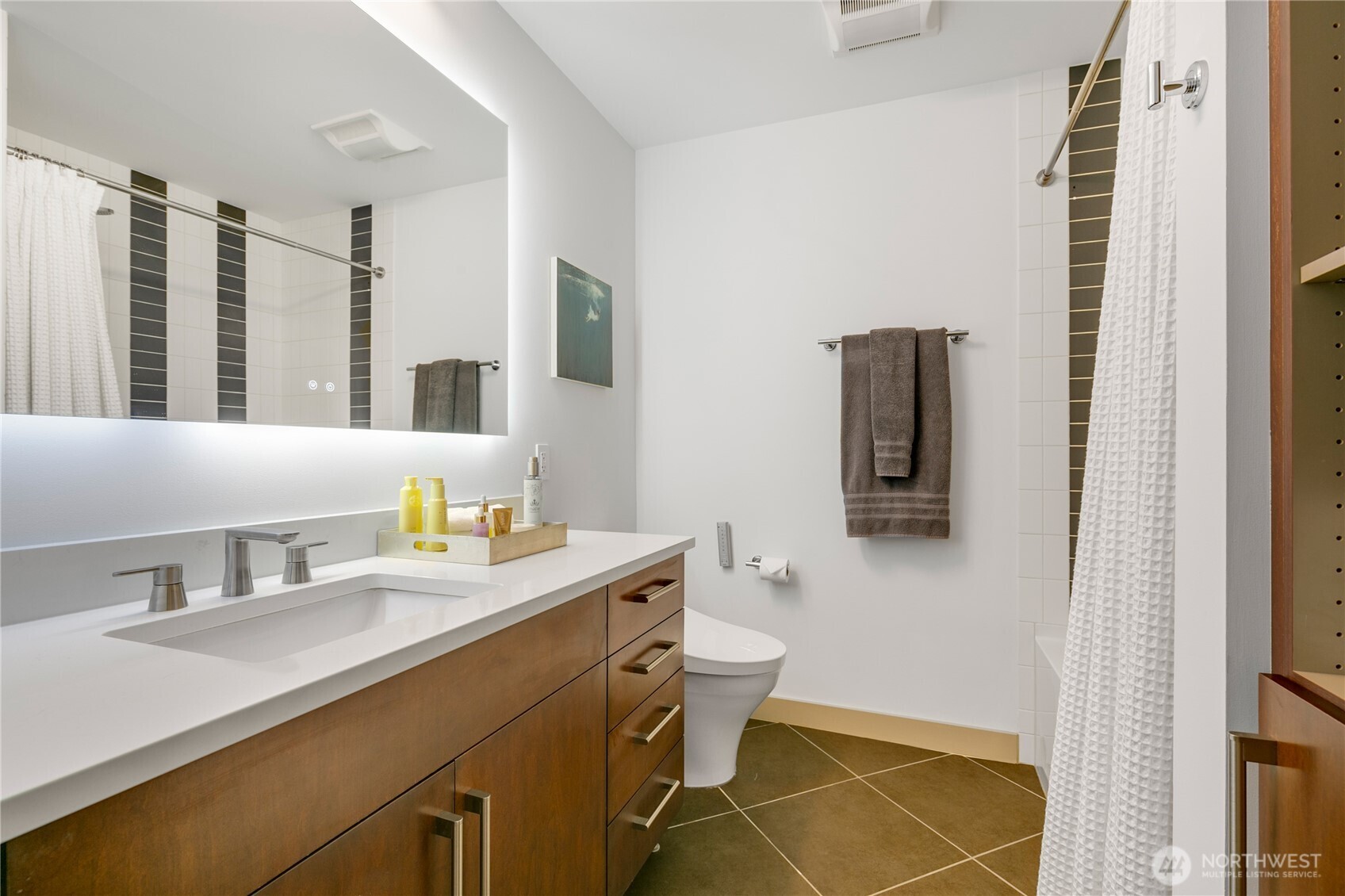 910 Lenora Street, Unit S1009 Seattle, WA 98121 - Photo 18 of 35 a bathroom with a sink mirror vanity and toilet