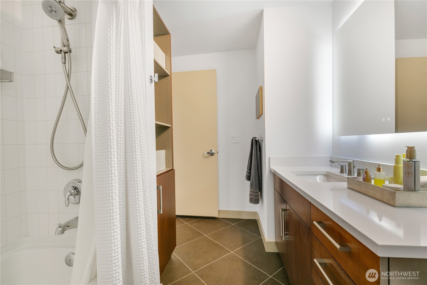 910 Lenora Street, Unit S1009 Seattle, WA 98121 - Photo 19 of 35 a bathroom with a sink vanity and a mirror