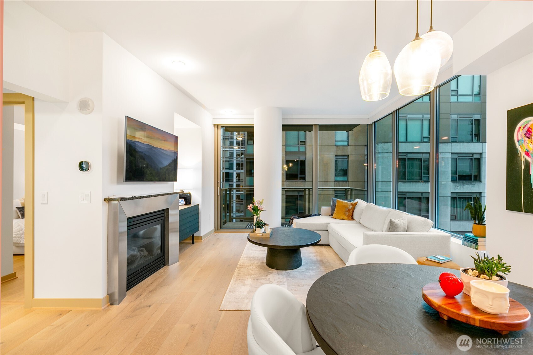 910 Lenora Street, Unit S1009 Seattle, WA 98121 - Photo 23 of 35 a living room with fireplace furniture and a flat screen tv