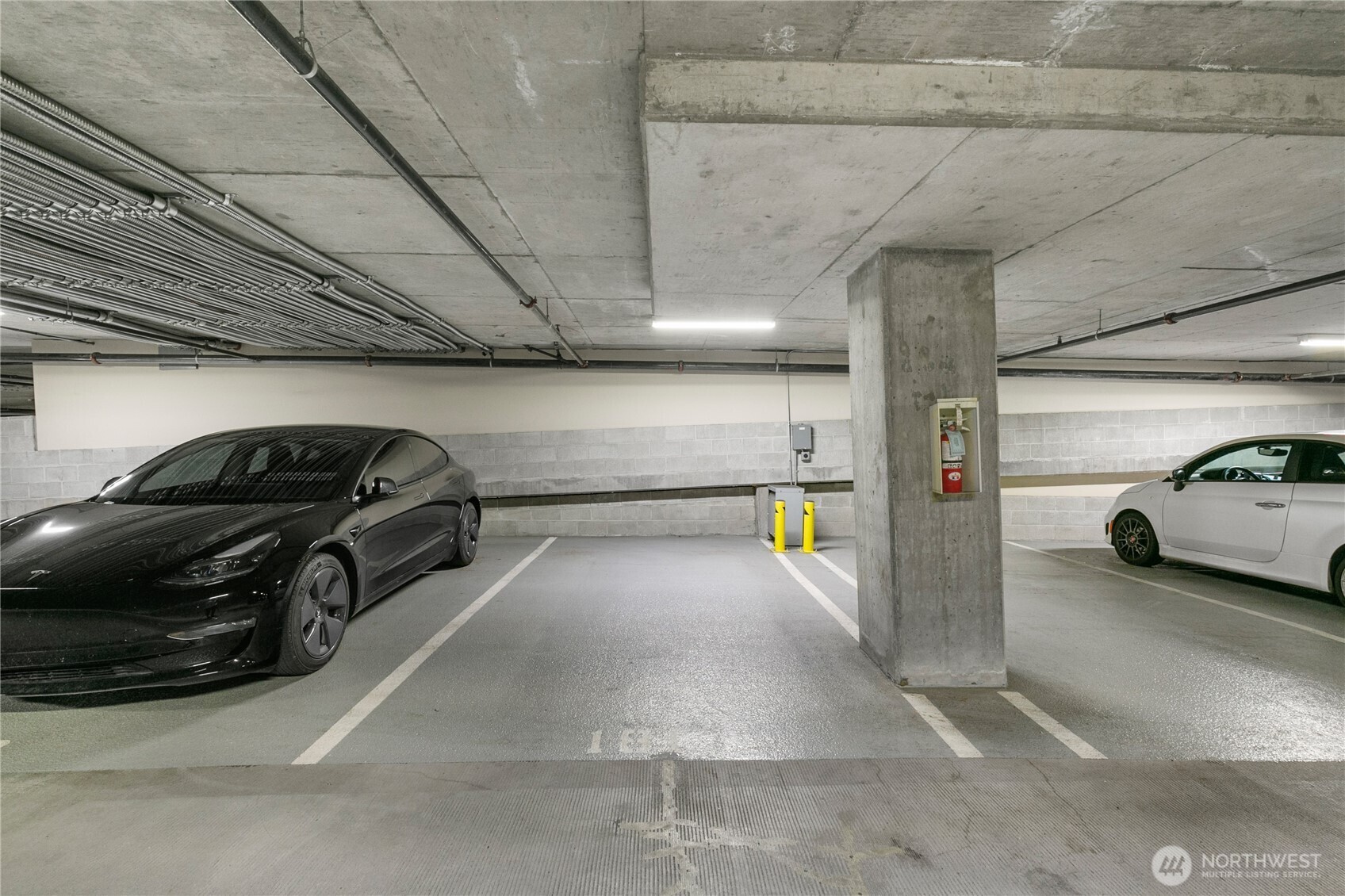 910 Lenora Street, Unit S1009 Seattle, WA 98121 - Photo 29 of 35 a view of parking garage with cars parked