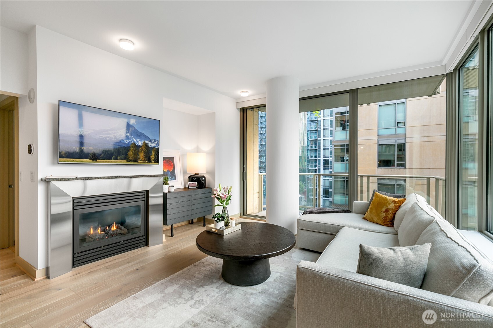 910 Lenora Street, Unit S1009 Seattle, WA 98121 - Photo 3 of 35 a living room with furniture a fireplace and a large window