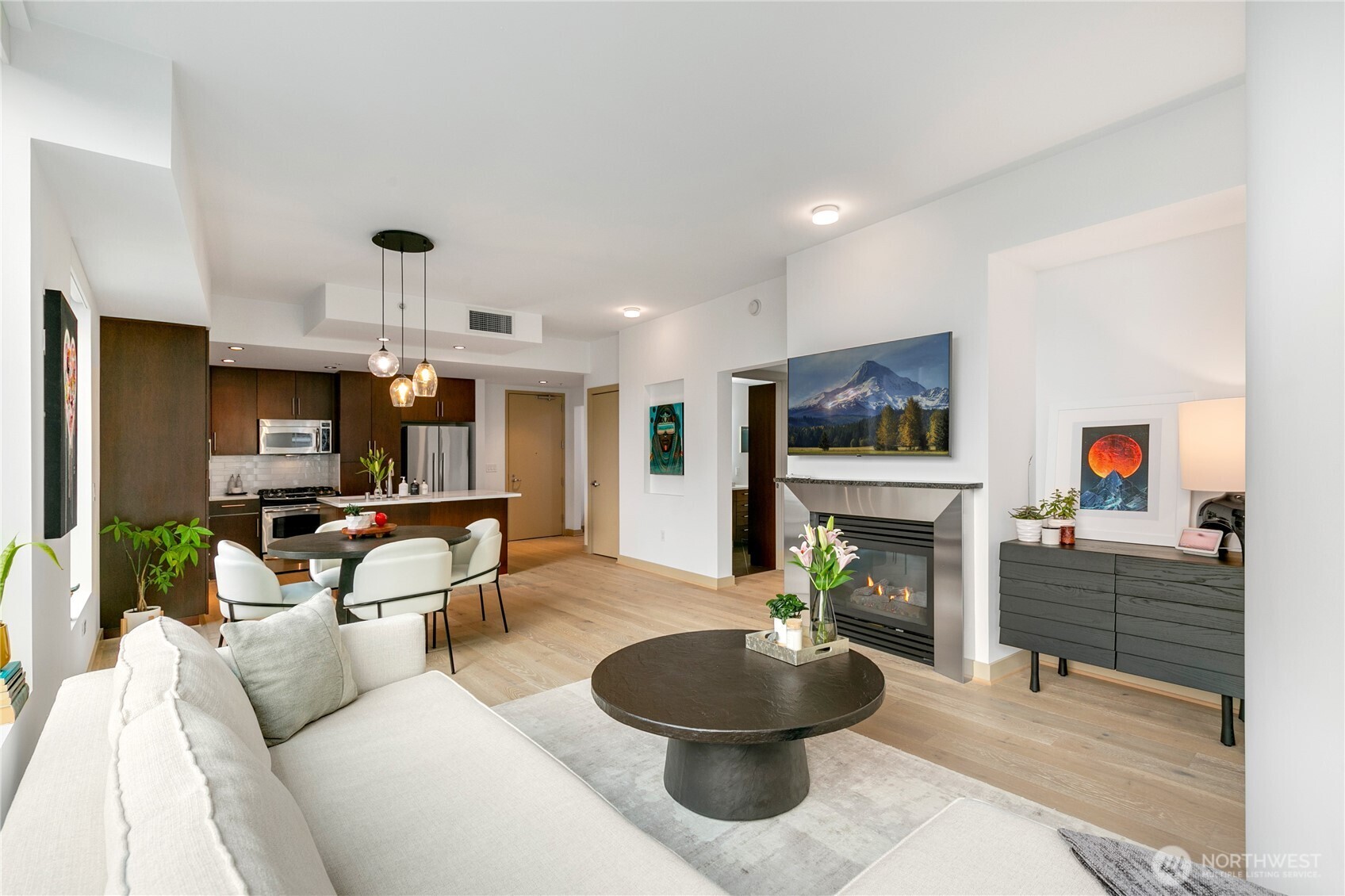910 Lenora Street, Unit S1009 Seattle, WA 98121 - Photo 7 of 35 a living room with fireplace furniture and a flat screen tv