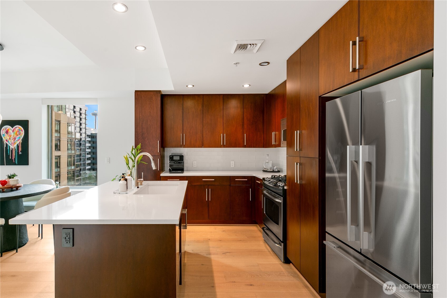 910 Lenora Street, Unit S1009 Seattle, WA 98121 - Photo 10 of 35 a kitchen with kitchen island a counter top space cabinets and stainless steel appliances