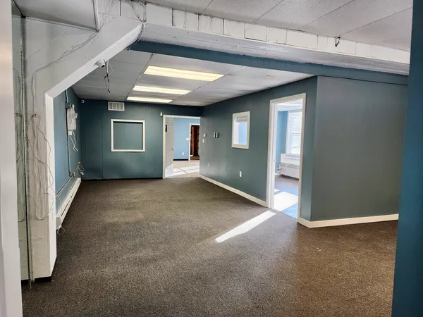 an empty room with a empty space and windows