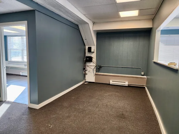 an empty room with windows and closet