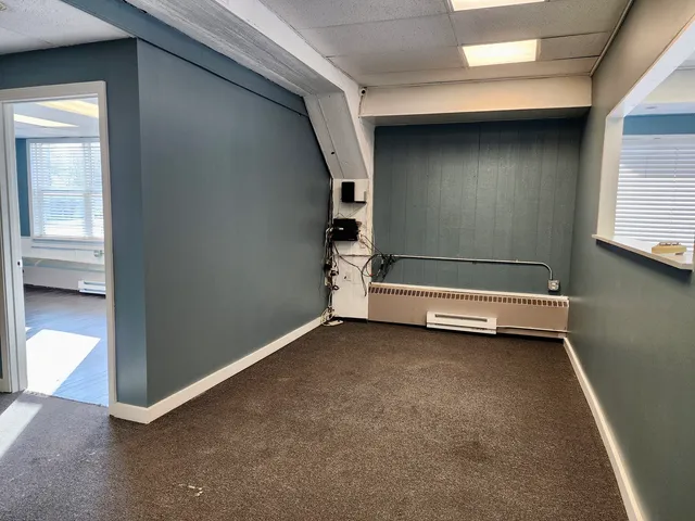 an empty room with windows and closet