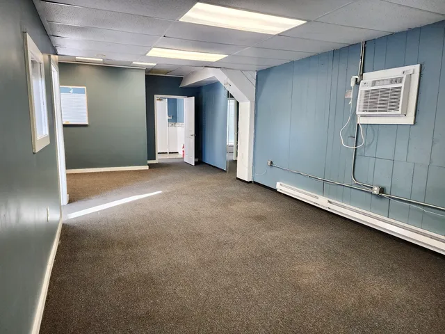 an empty room with a empty space and windows