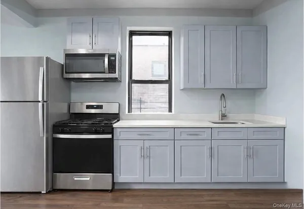 a kitchen with stainless steel appliances granite countertop a stove a sink and a refrigerator