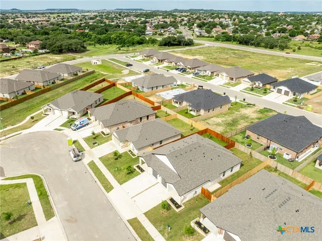 an aerial view of residential houses with outdoor space