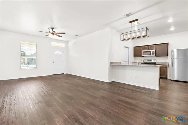 a view of kitchen with sink microwave and stove