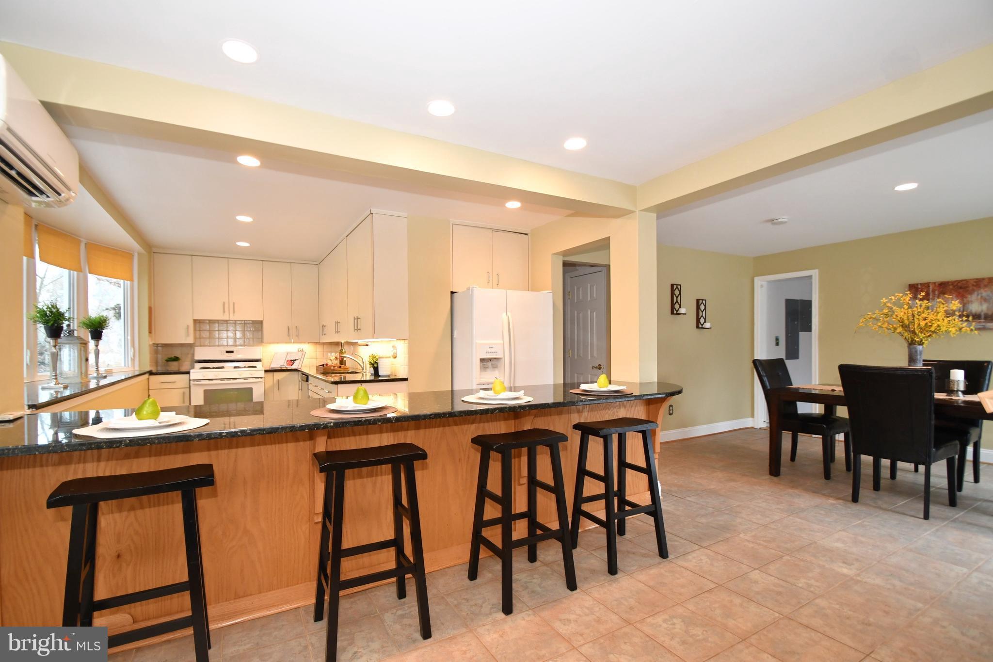 2103 Laurel Brook Road Fallston, MD 21047 - Photo 12 of 30 a kitchen with stainless steel appliances granite countertop table chairs sink and cabinets