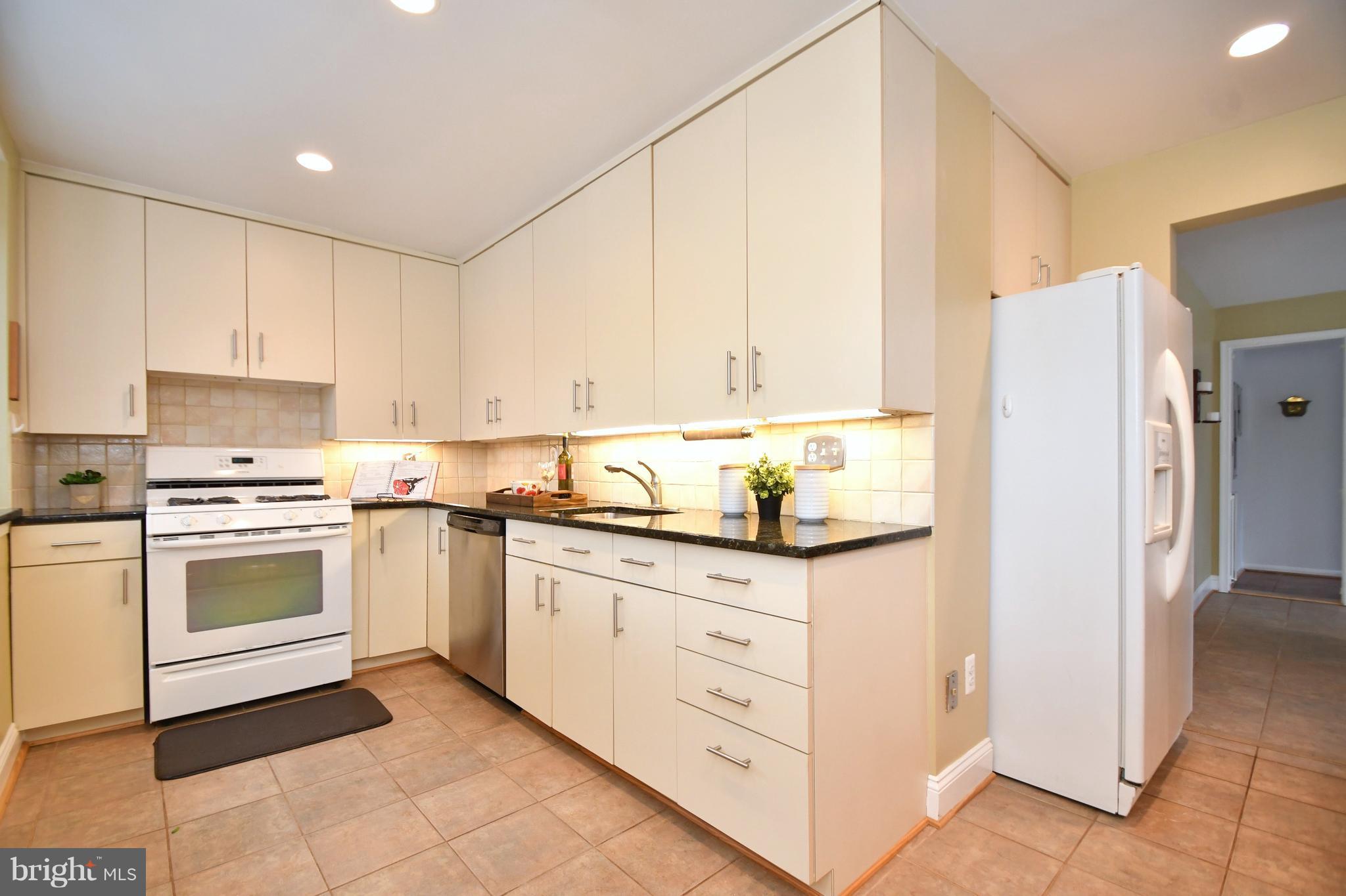 2103 Laurel Brook Road Fallston, MD 21047 - Photo 14 of 30 a kitchen with granite countertop white cabinets and white appliances