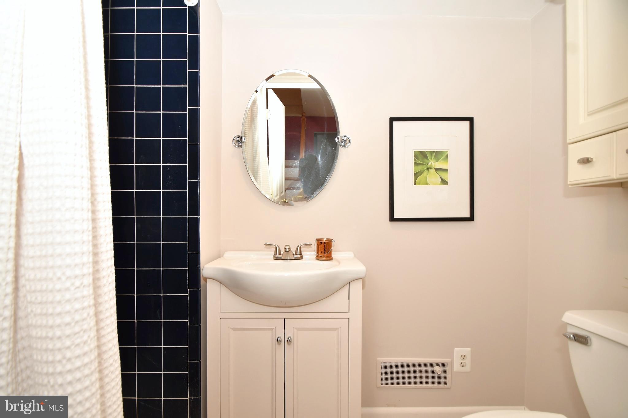2103 Laurel Brook Road Fallston, MD 21047 - Photo 24 of 30 a bathroom with a sink mirror and a toilet