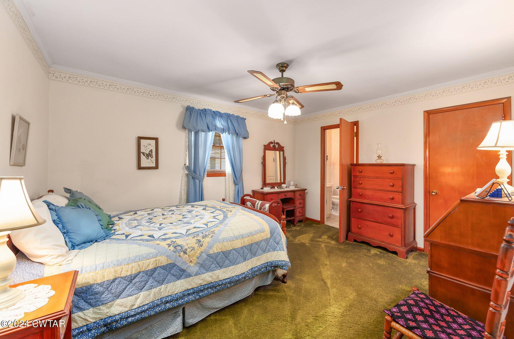101 Hadley Drive Rutherford, TN 38369 - Photo 13 of 25 a bedroom with a bed a dresser and a chandelier