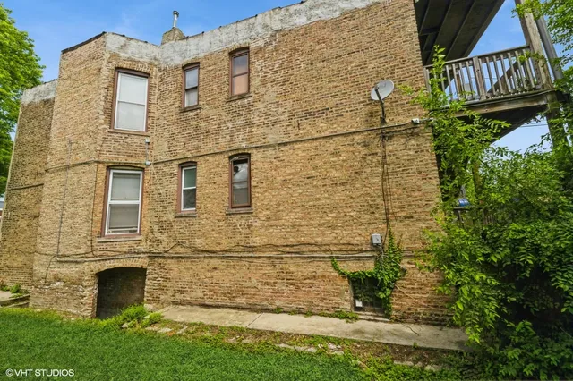 front view of a brick house with a yard